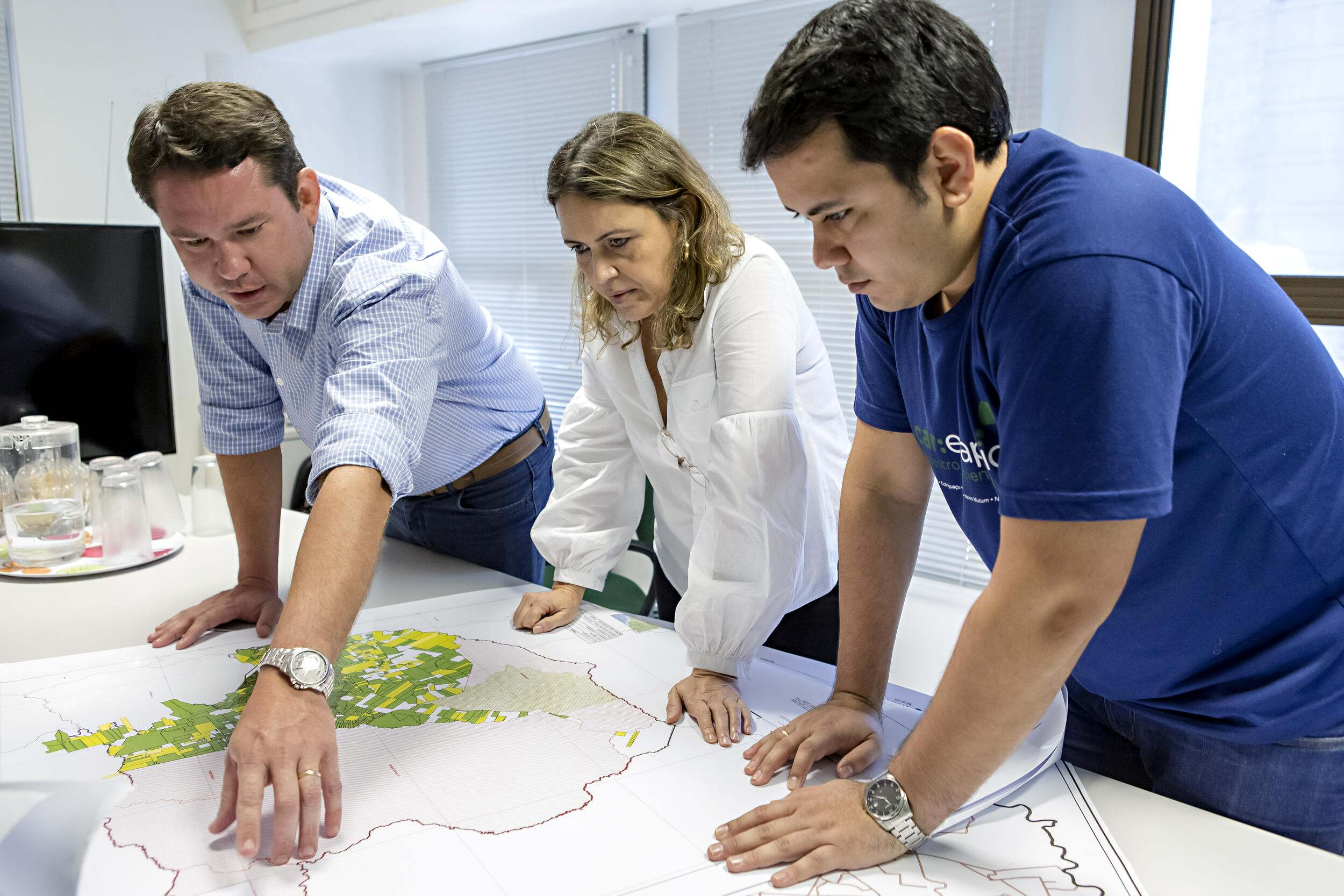 Staff members at The Nature Conservancy’s office in Mato Grosso state looking at maps whose data will be entered into the Rural Environmental Registry, Brazil.